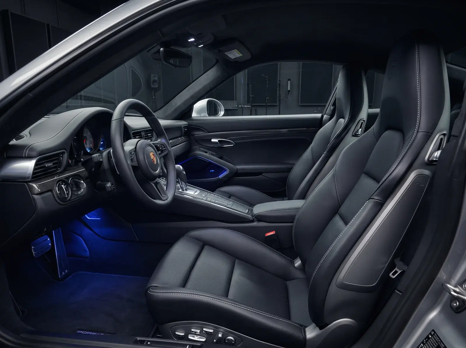 Detailed Porsche 911 interior with black leather seats and carbon fiber trim after interior detailing in St. Louis